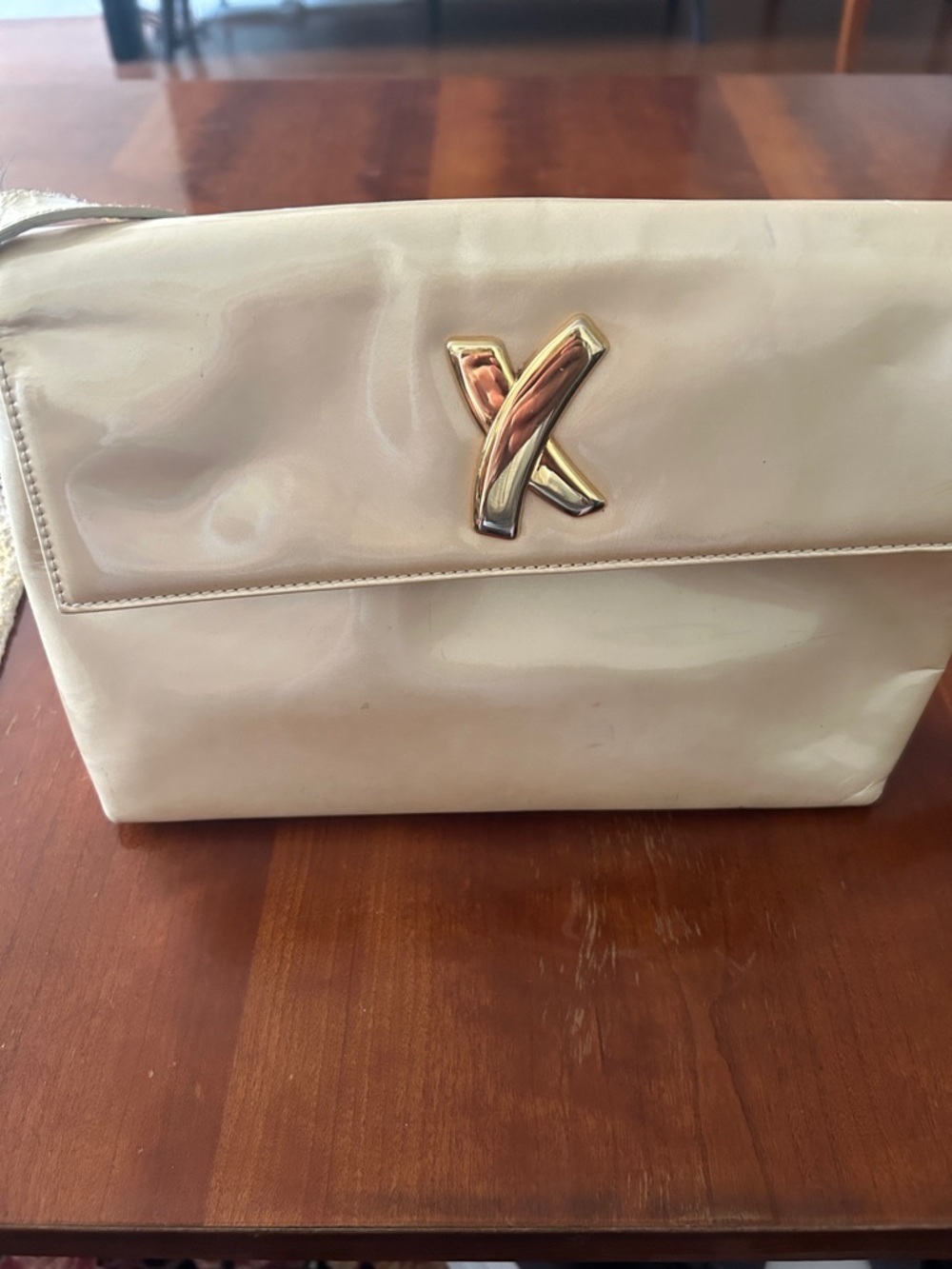Paloma Picasso Cream Patent Wristlet with Gold X Emblem